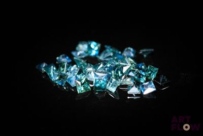 some very pretty blue diamonds on a black surface