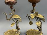 pair of brass candlesticks with flowers and leaves