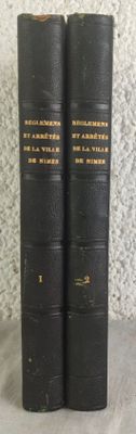 two black books sitting on top of a table next to each other
