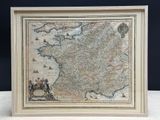 an old map of france is displayed in a frame on a table