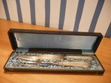 a silverware set in a case on a wooden table