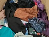 a cardboard box filled with clothes and other items