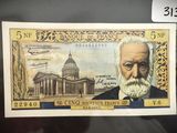 un vieux billet de banque sur lequel figure l'image d'un homme barbu