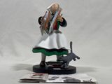figurine of a woman reading a book with a cat on a table