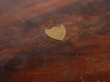 an image of a close up of a wooden table with a gold plate on it
