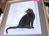 a picture of a black cat sitting in a picture frame