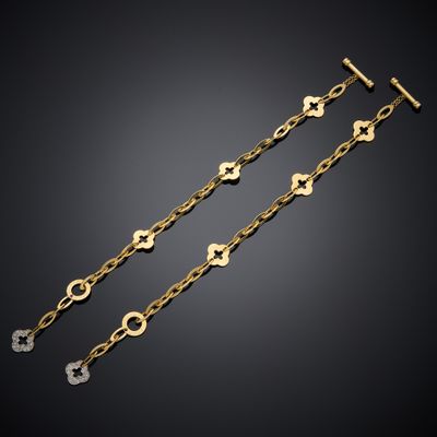 a pair of gold and diamond bracelets