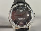 a close up of a watch with a black dial