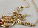 gold plated necklace with garnett and red glass beads
