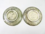 pair of antique silver plated dishes with engraved designs on them