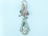 silver and turquoise earrings with pearls on a blue background