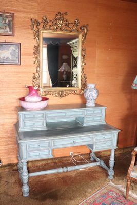 a blue desk with a mirror on it in a room
