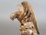 a statue of an eagle that is sitting on a rock