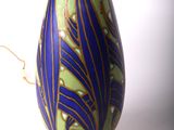 a vase with a flower in it sitting on a table