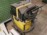 a machine that is sitting on the ground next to a pile of wood