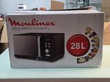 a box that has a microwave on it on a table