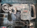an overhead view of a drill in a tool box with other tools in it