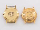 an image of two gold watches on a white surface