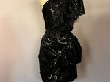 a black dress on a mannequin on a stand