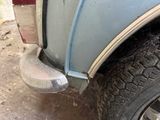 a close up of a car with a tire on the ground