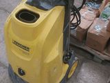 a yellow pressurer that is sitting on the ground