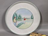 a plate with a picture of two men playing golf