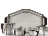 a silver plated tea set with four cups and a tray