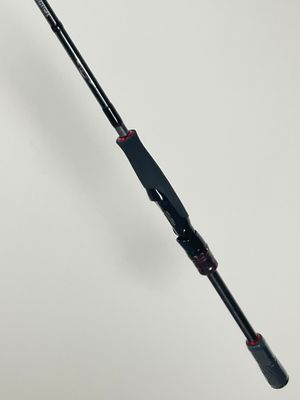 a close up of a fishing rod on a white surface