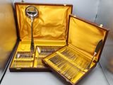 a wooden case with silverware in it on a table
