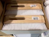 a box of cleaning brushes sitting on a toilet
