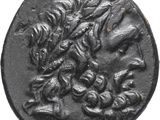 a close up of a black coin with a dragon on it
