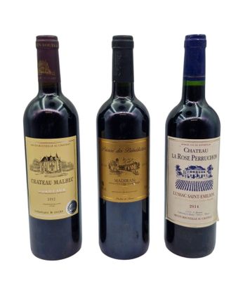three bottles of wine are lined up on a white surface