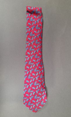pink and blue paisley necktie on a gray background