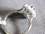 a close up of a ring with a flower on it