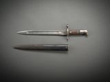 two knives on a table with a knife in the middle of them