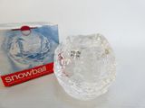 a clear glass bowl sitting next to a box of snowball