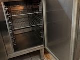 an open door of a stainless steel oven in a kitchen