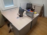 a desk with a computer monitor and a laptop on it