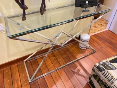 a glass table with a horse statue on top of it