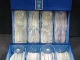 six empty glasses in a blue box on a table