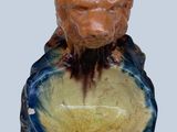 a figurine of a man with a lion head on it ' s head