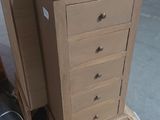 a small chest of drawers sitting on a pallet