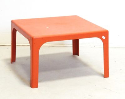 a small orange table with a small white dot on it