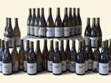 many bottles of wine that are stacked on top of each other