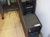 a microwave oven sitting on top of a counter next to a computer