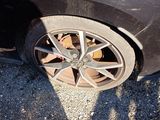 a black car with a flat tire on the street
