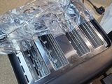 a toaster sitting on top of a table covered in plastic wrap