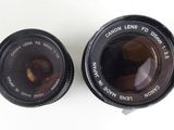 two lens lenses are sitting side by side on a white surface