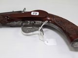 an old gun with a wooden handle on a white surface