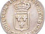 a close up of a silver coin with a crown on it